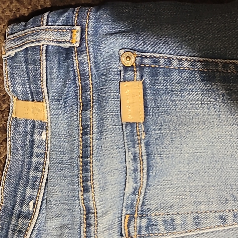 Worn jeans with holes